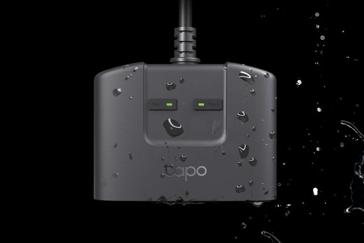Tapo's smart plug wet and against a dark background.