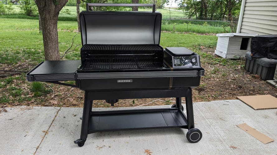 Traeger Grills Ironwood XL lid open sitting on a concrete patio.