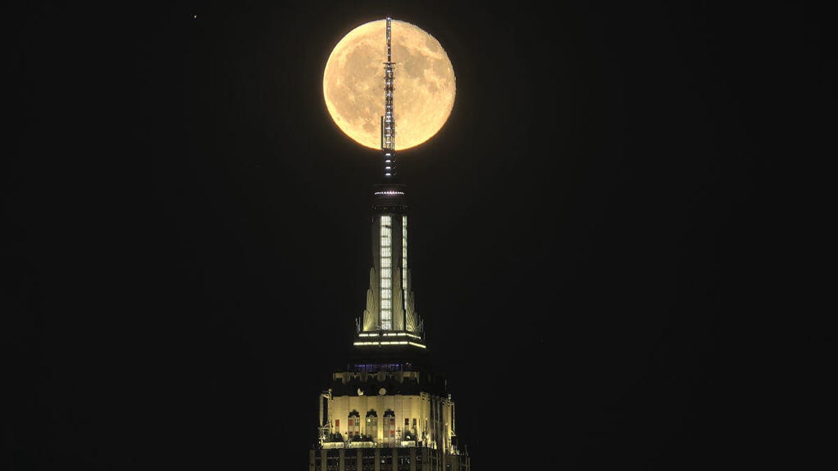 Saturn and the moon shine behind New York's Empire State Building