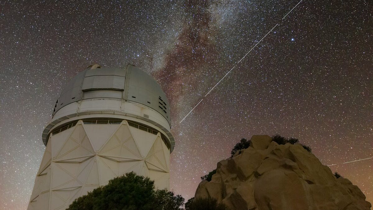 The Nicholas U. Mayall 4-meter Telescope from below, against a backdrop of a starry sky