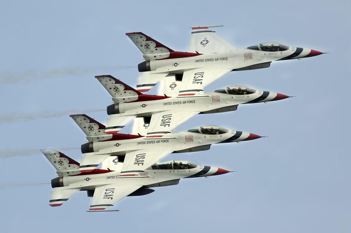 Four F-16 aircraft of the Air Force Thunderbirds flying in tight formation