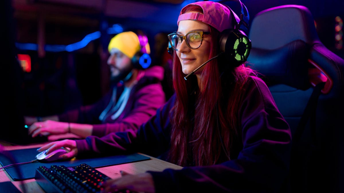 female gamer playing eSports on desktop PC