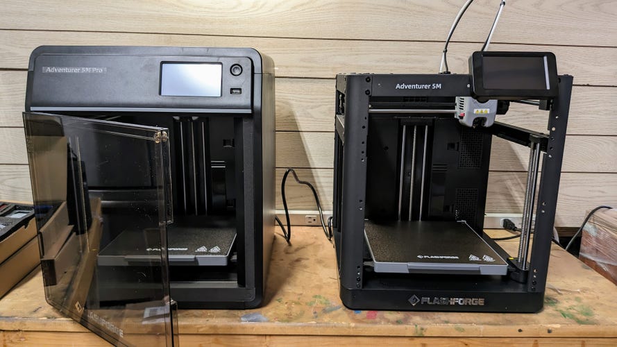 2 Black 3D printers on a workbench