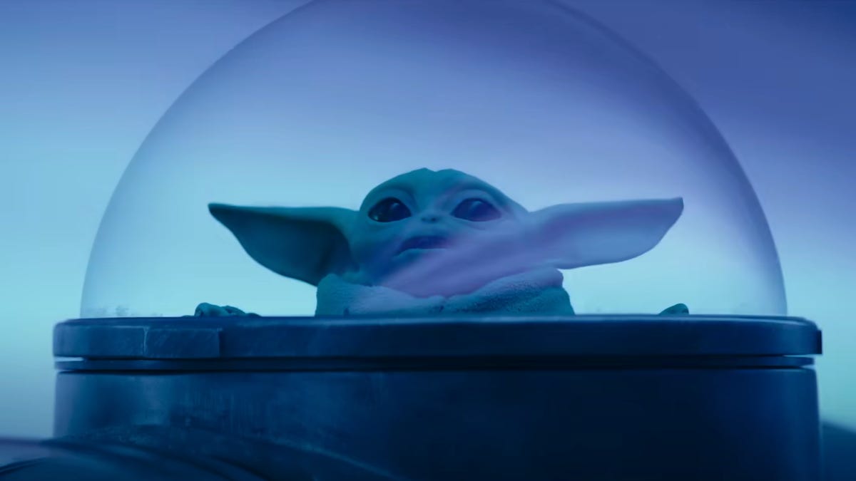 Grogu gazes out of a bubble viewport as his ship travels through hyperspace in The Mandalorian season 3