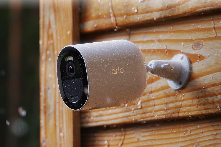 Arlo's Go 2 camera mounted on wooded exterior siding in the rain. 