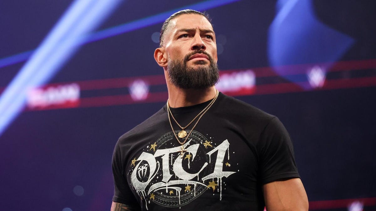 An image of WWE superstar Roman Reigns in a black t-shirt that says OTC1.
