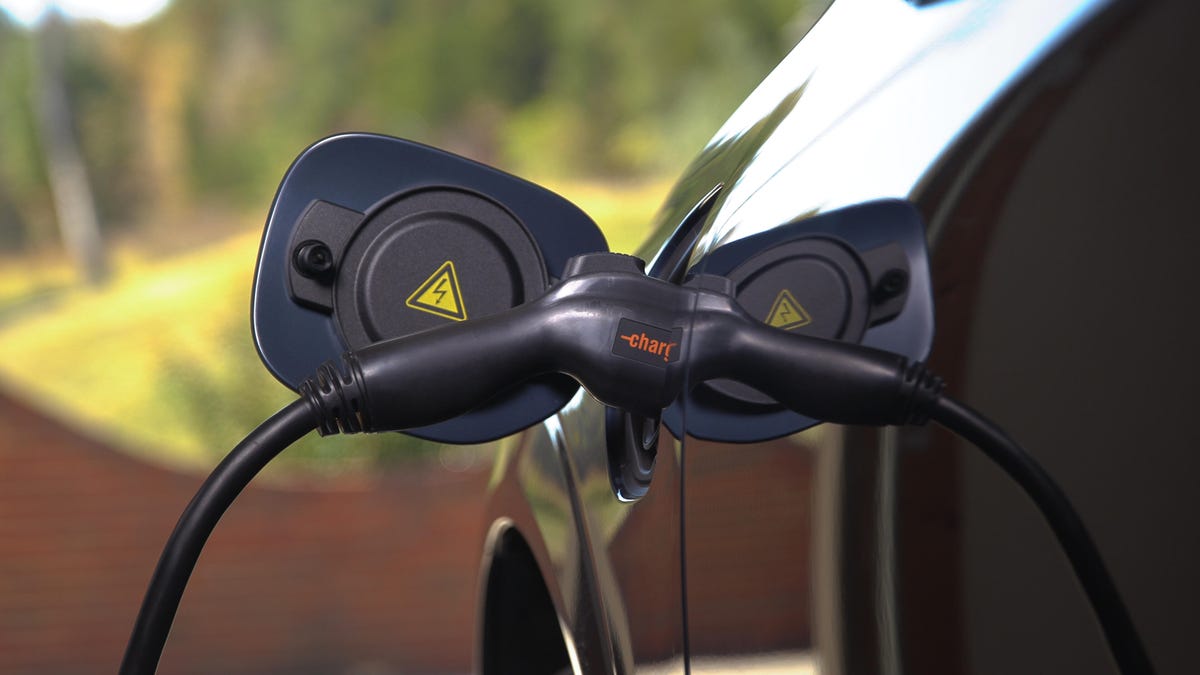 a car charger plugged in to an electric vehicle