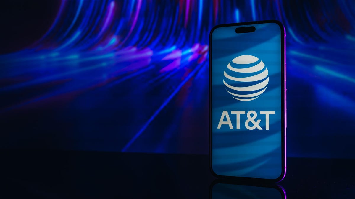 AT&T logo on iPhone screen. The phone is featured against a blue backdrop.