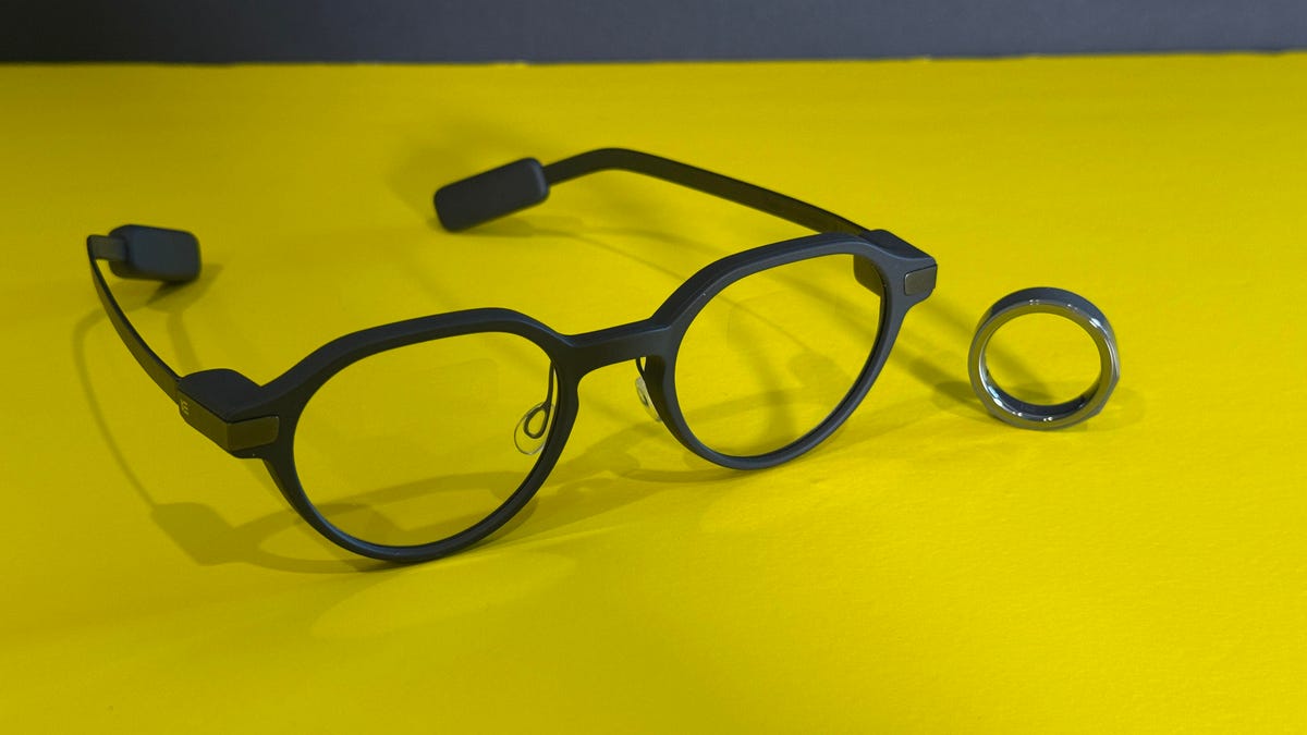 EvenRealities G2 smart glasses and R1 smart ring on a yellow table