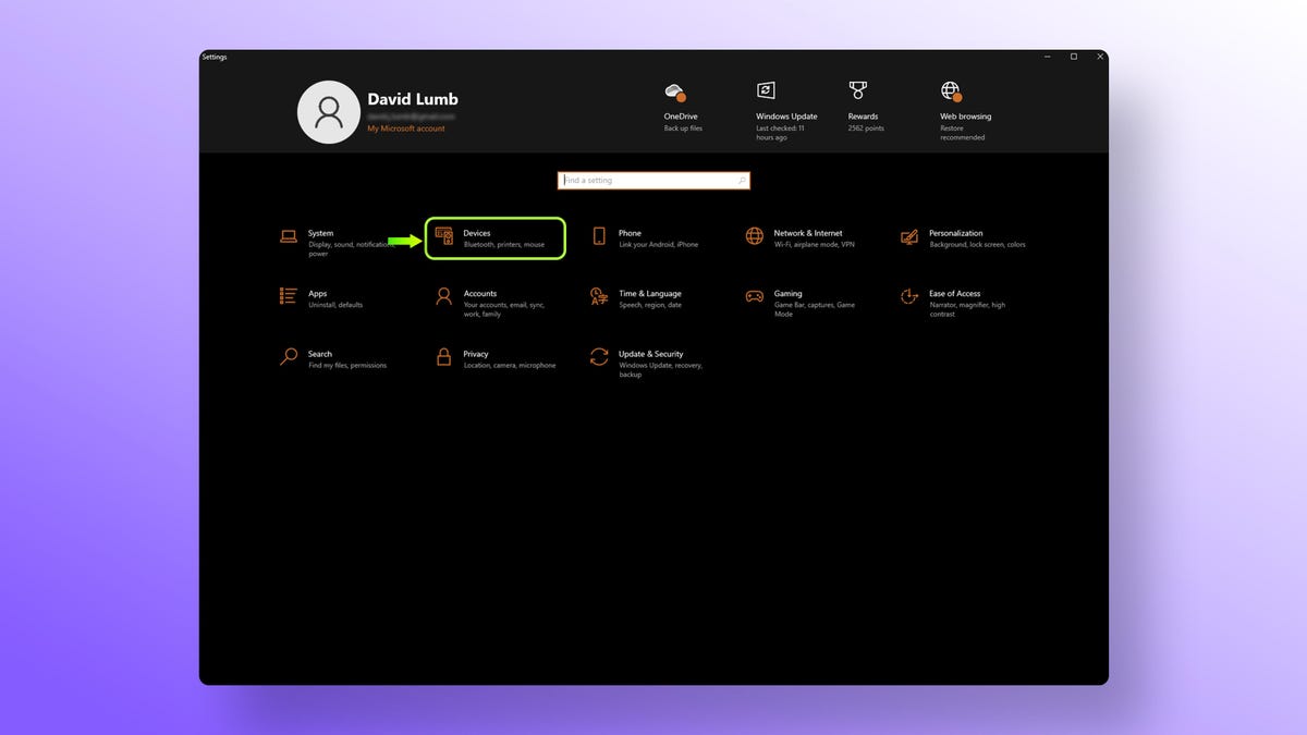 A screenshot of a PC settings screen with a green arrow pointing to the Devices tab.