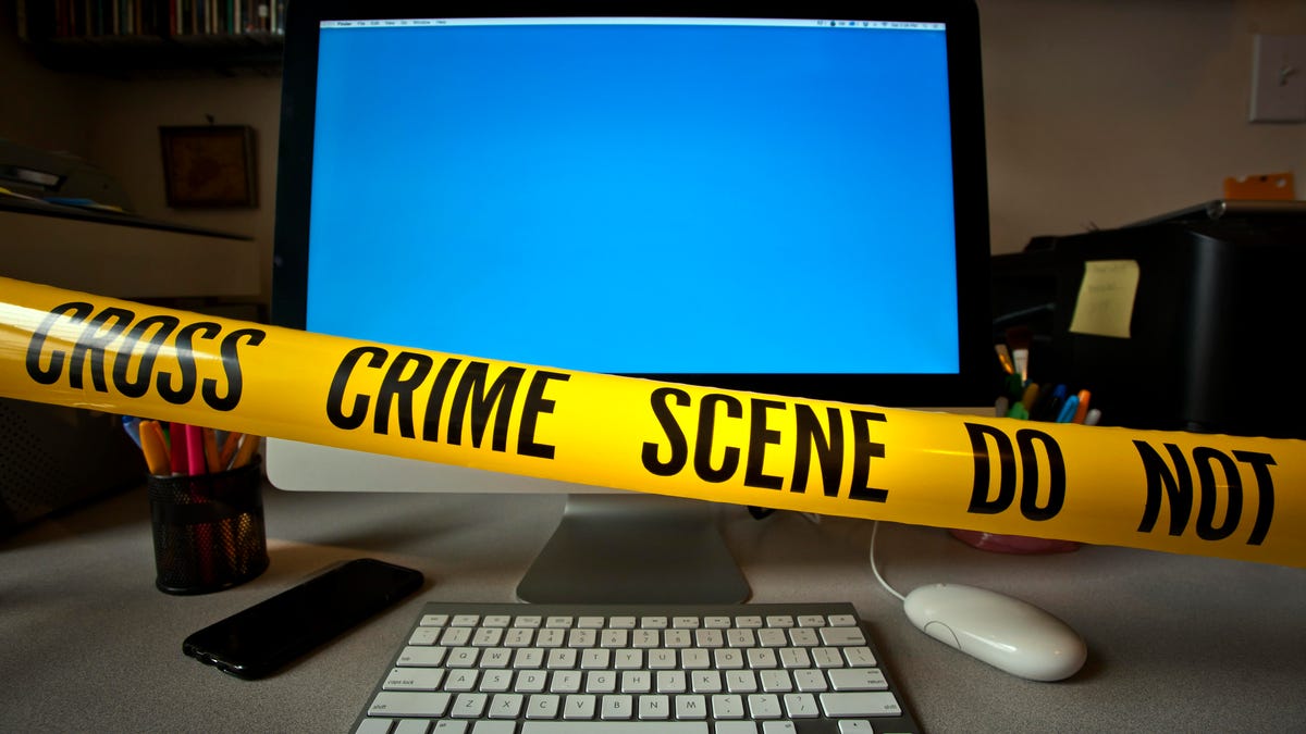 A computer screen roped off with crime scene tape.