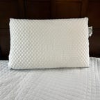 Pluto Pillow on a bed