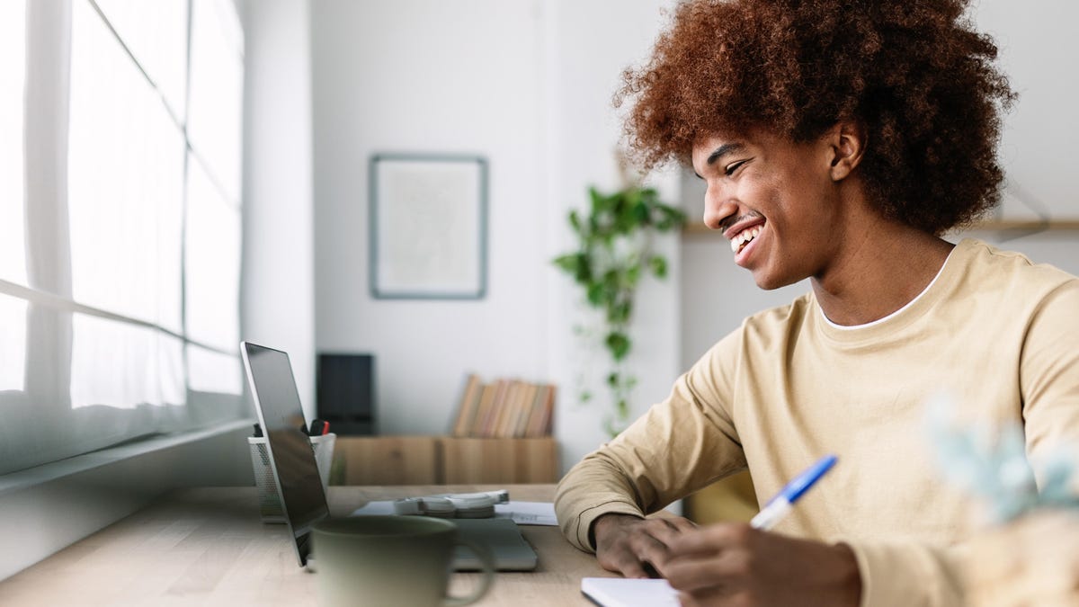 man-smiling-using-laptop