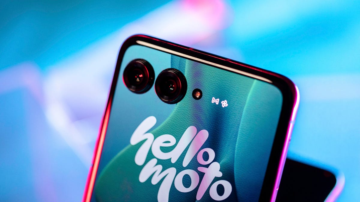 foldable phone with two camera holes in a back screen that displays the words "hello moto"
