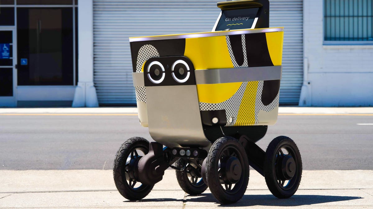 serve street bot, four-wheeled robot with yellow and black paint, big googly eyes