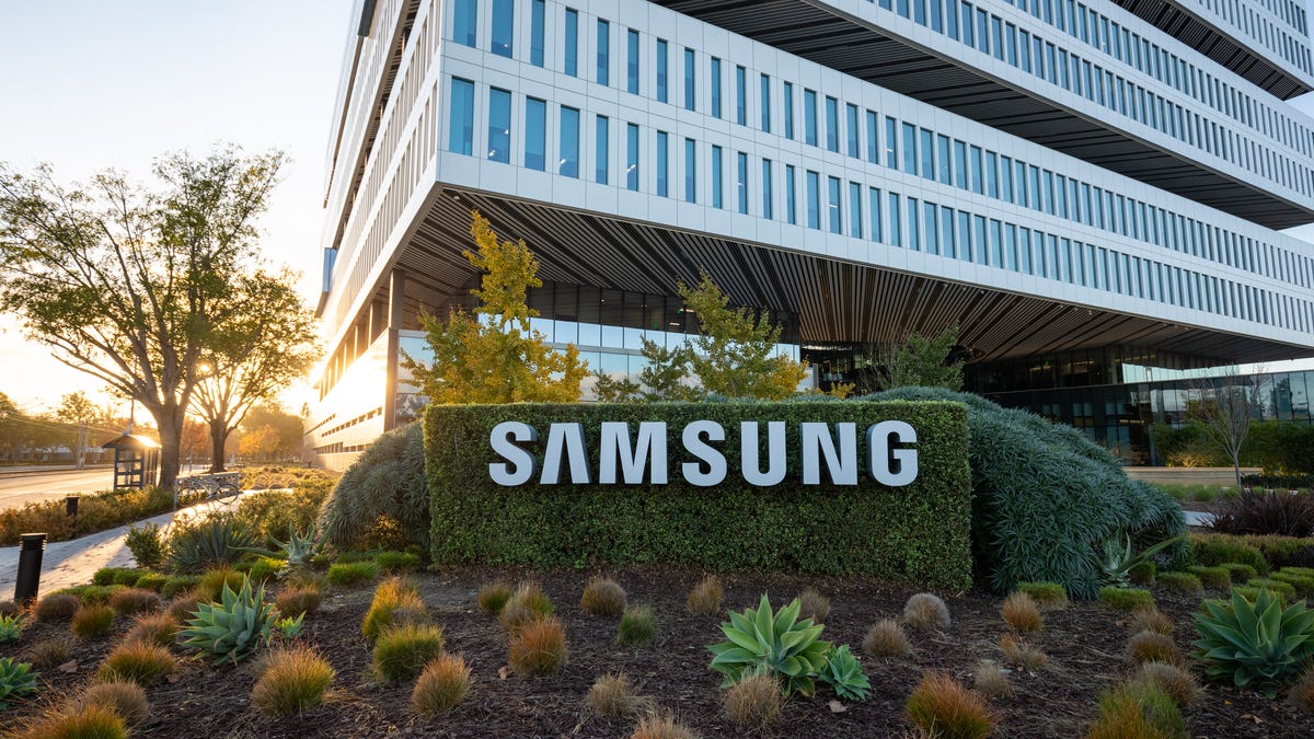 The sun sets behind a large building on Samsung's San Jose campus