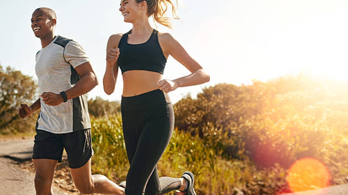 a young fit couple enjoying an outdoor run