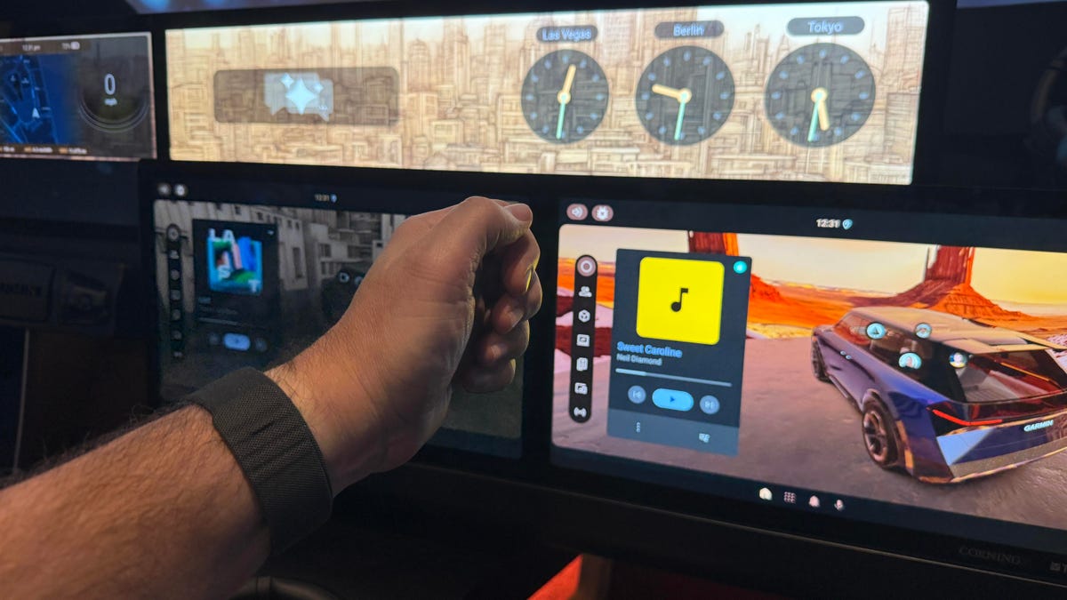A hand wearing Meta's neural band, gesturing to several smart screens in a car cabin
