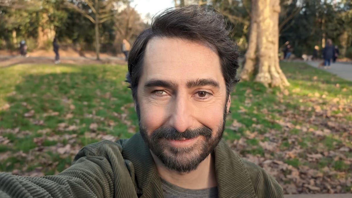 Selfie of a man with a beard, outside in a park
