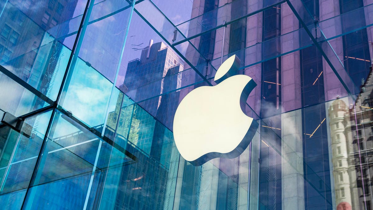 apple logo on shiny building with colored glass windows