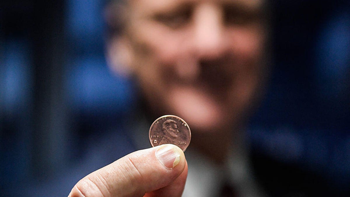 Treasurer of the United States Brandon Beach holds the last penny stamped at the US Mint on November 12, 2025 in Philadelphia, Pennsylvania.
