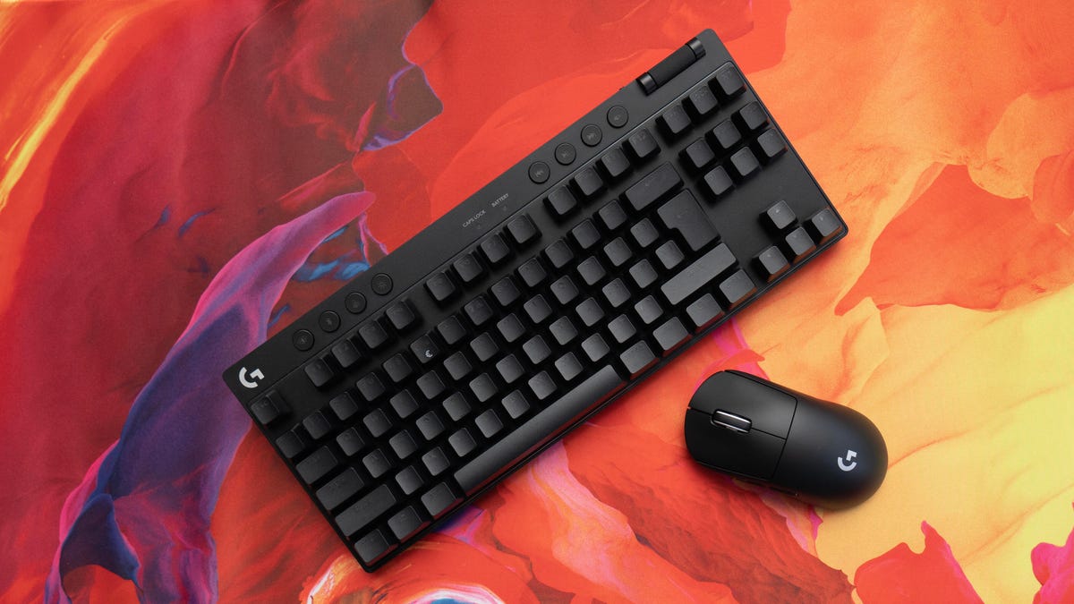 Logitech gaming keyboard and mouse on a red, yellow and orange background