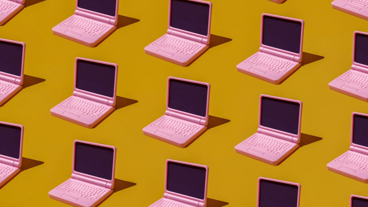 An image showing pink laptops on a yellow background gettyimages-2207967834