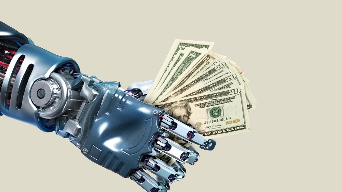 A robot hand clutches US paper currency