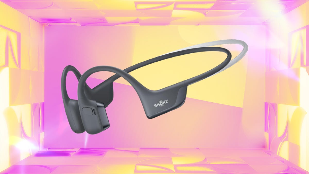 Shokz headphones on red CNET background