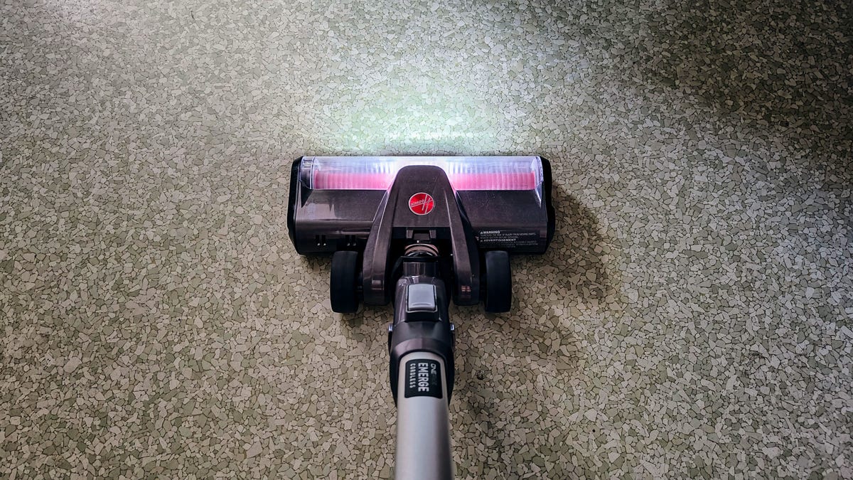 The Vactidy V8 Pro brush head and LED lights cleaning low-pile carpet.