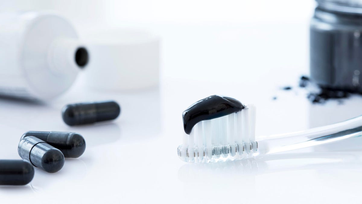 Charcoal toothpaste on a toothbrush