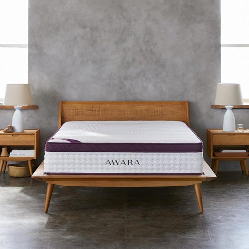 Awara Premier mattress on top of a wooden bed frame in a grey room. 