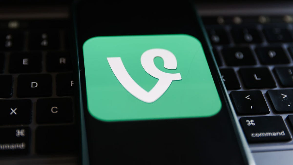 Vine logo displayed on a phone screen and a laptop keyboard