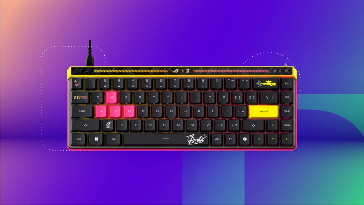 A black, yellow and pink gaming keyboard against a purple gradient CNET background.