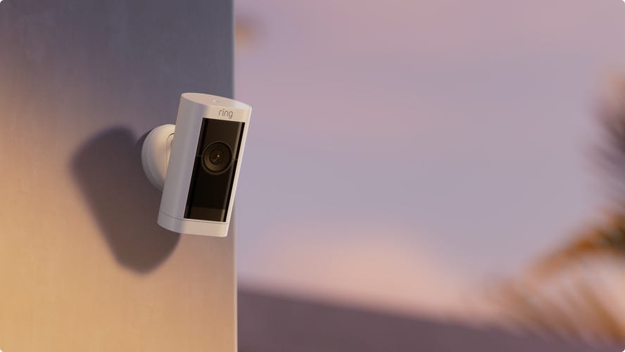 The wireless Ring Stick-Up Cam Pro sits perched on the corner of a home, keeping an eye on the exterior of the property.
