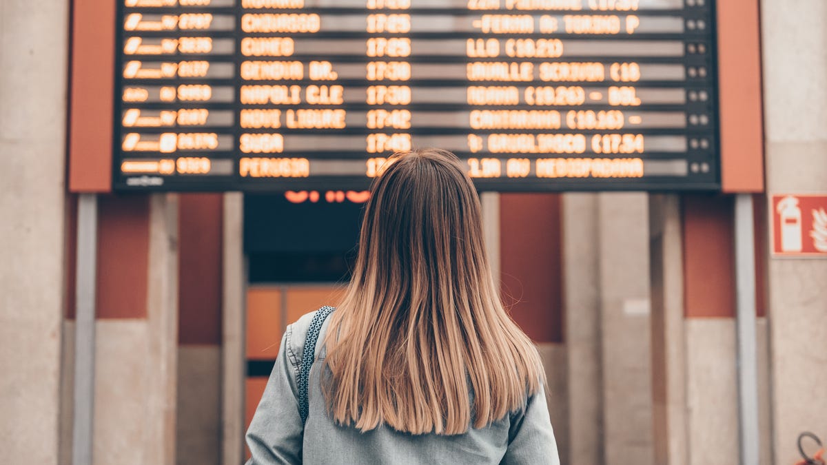Woman looking at flight schedules in an airport