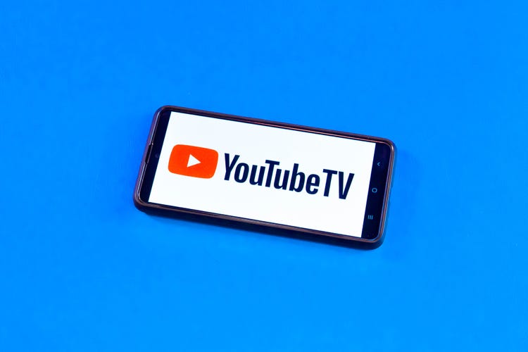 A phone with the YouTube TV logo against a light blue background. 