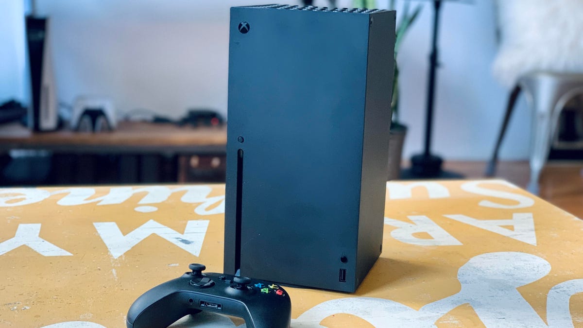 Xbox Series X and controller on a table.