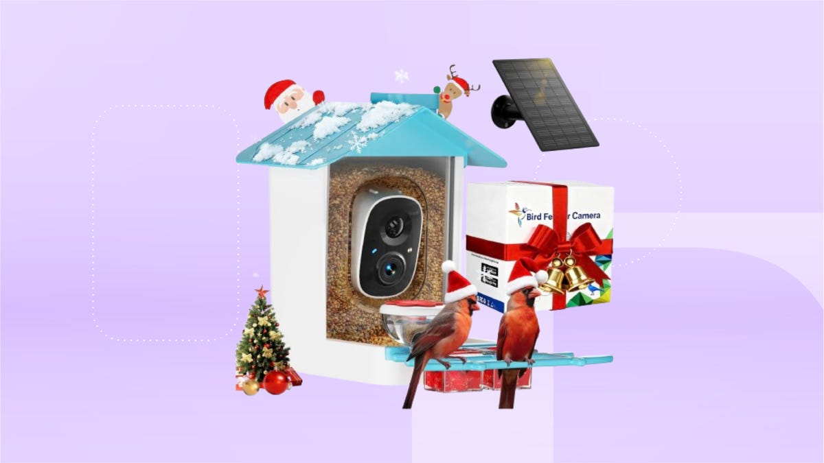 white bird feeder with small Christmas tree to the left, camera in its fake tree bark hole, and mini solar panel. Background: lavender CNET background.