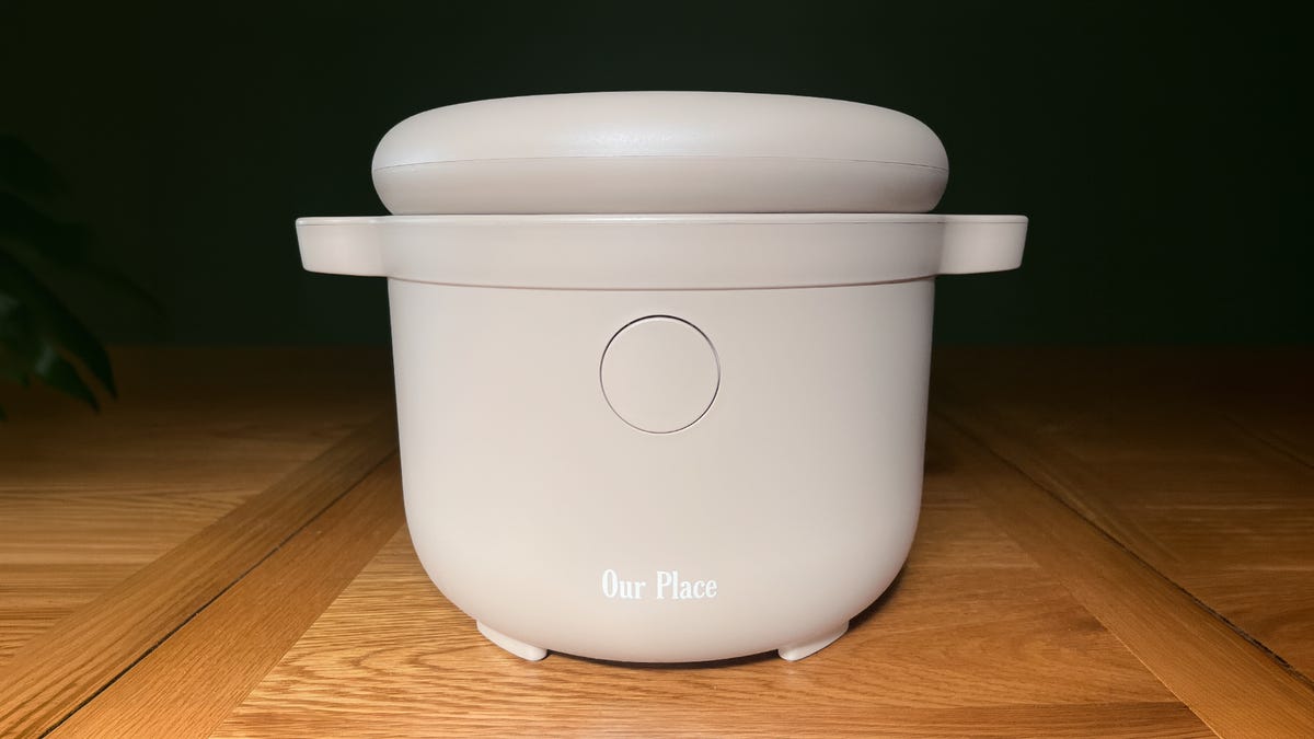 a tan rice cooker on a wooden table