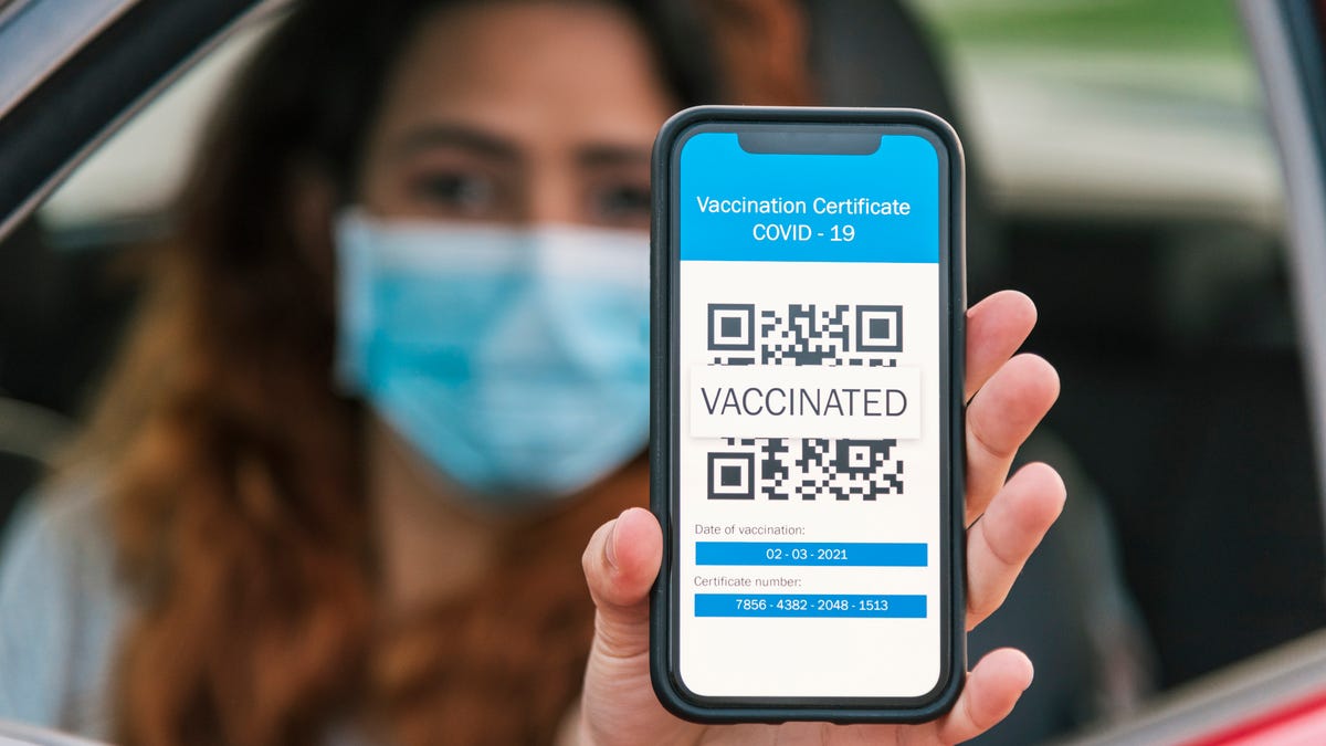 Woman showing digital proof of vaccination on a smartphone