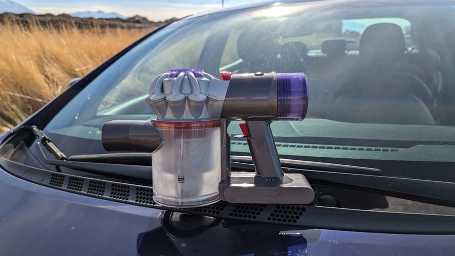 Dyson car vac on hood of car