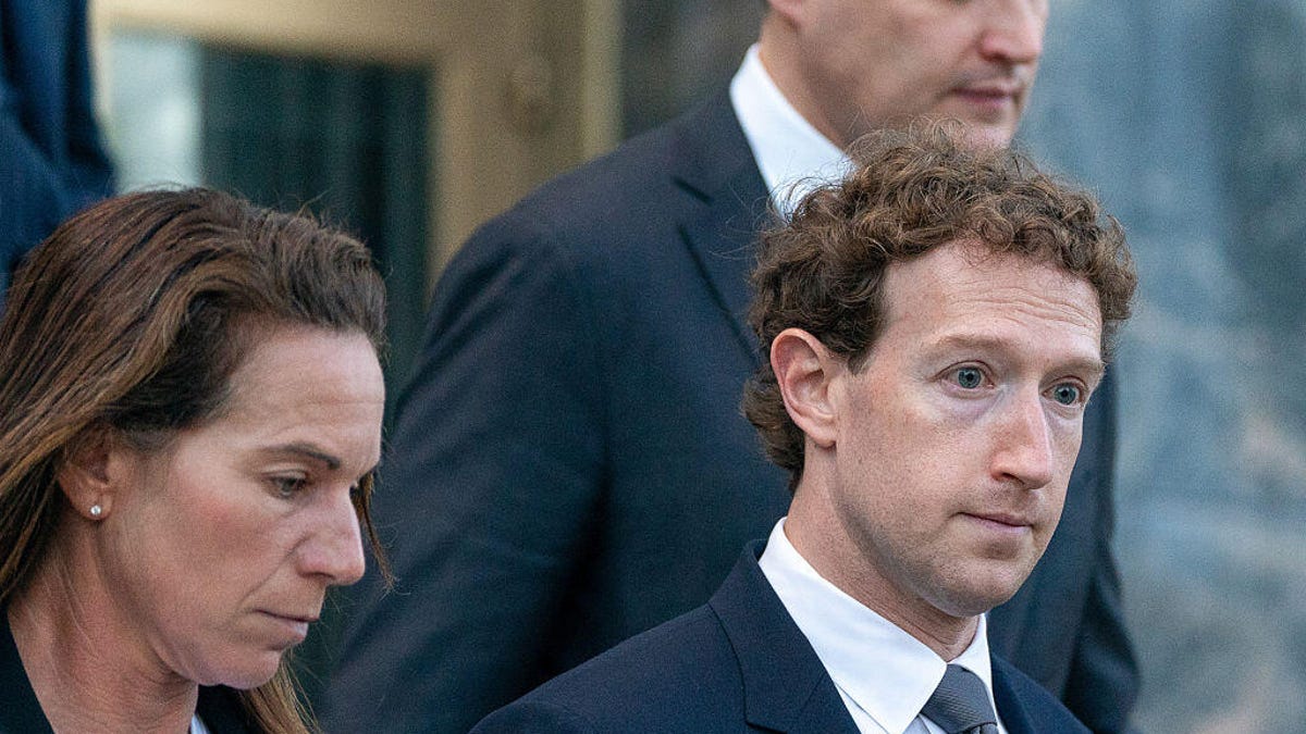 Mark Zuckerberg leaving a courthouse in a suit.
