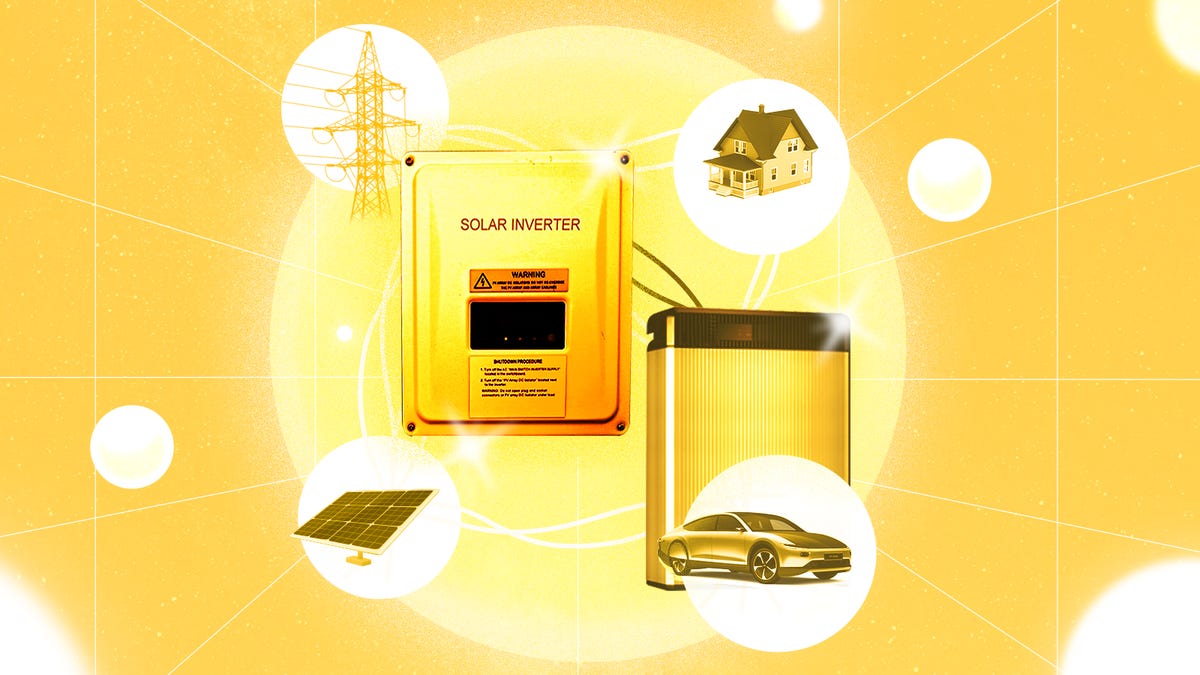 A small white house with solar panels among some trees.