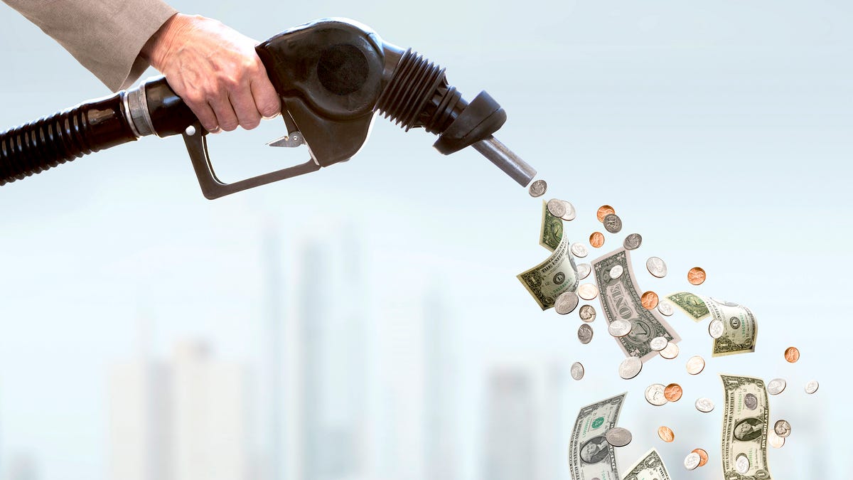 Money sticking out of a car's gas tank