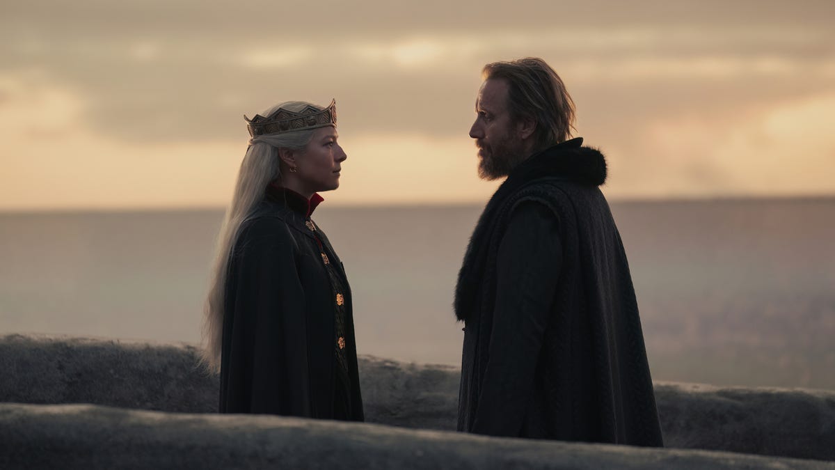 Queen Rhaenyra and Otto Hightower facing each other on a bridge