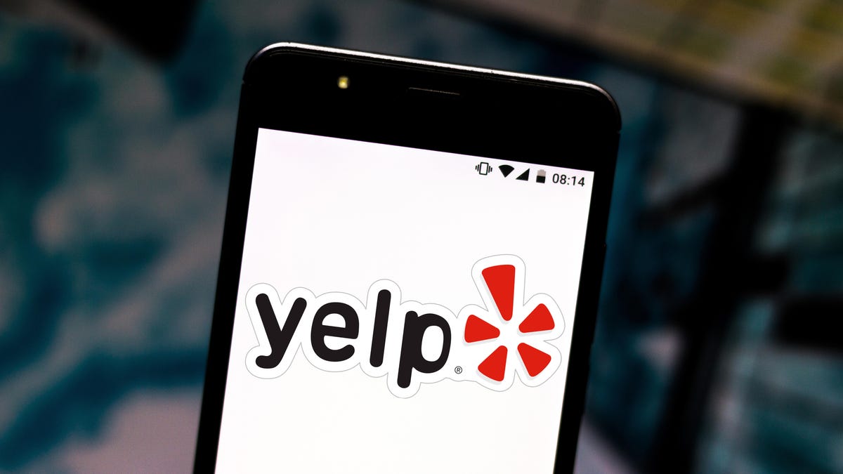 In this photo illustration the Yelp logo is seen displayed