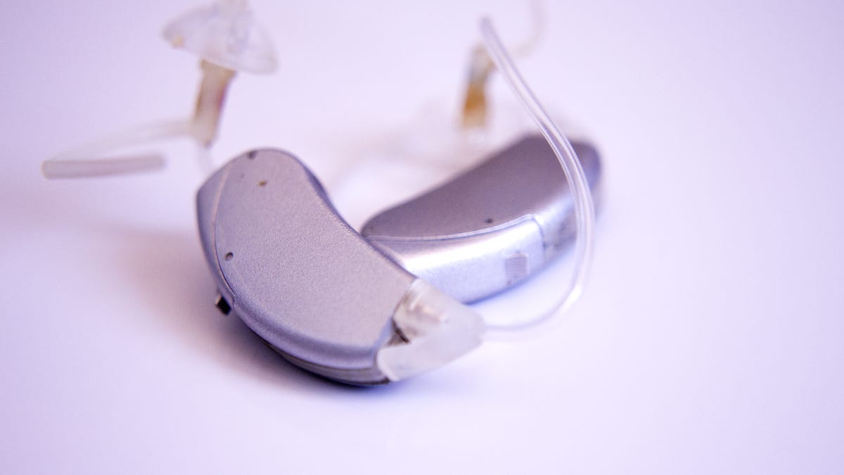 Close up of hearing aid against lilac background