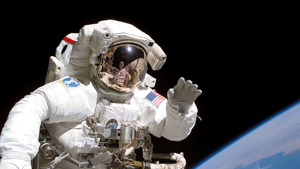US astronaut Joseph Tanner waves during a 2006 spacewalk.