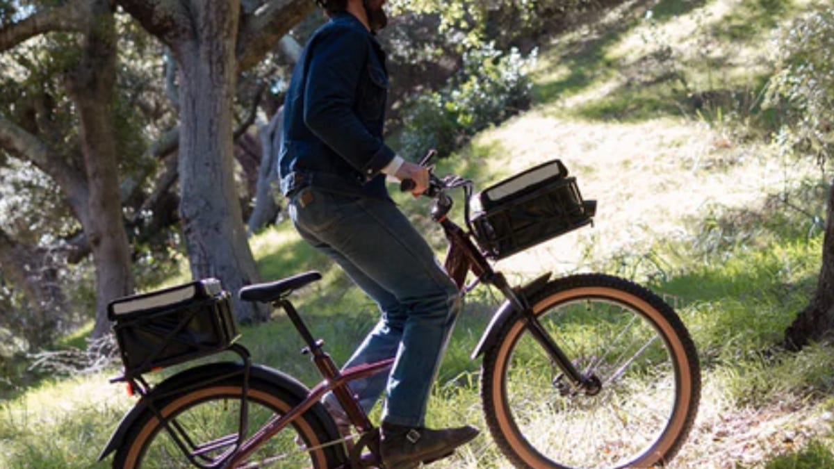 a man on a Rad Power Bike cycling through a wooded trail